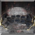 D02. Brass andirons and fireplace candle holder. 